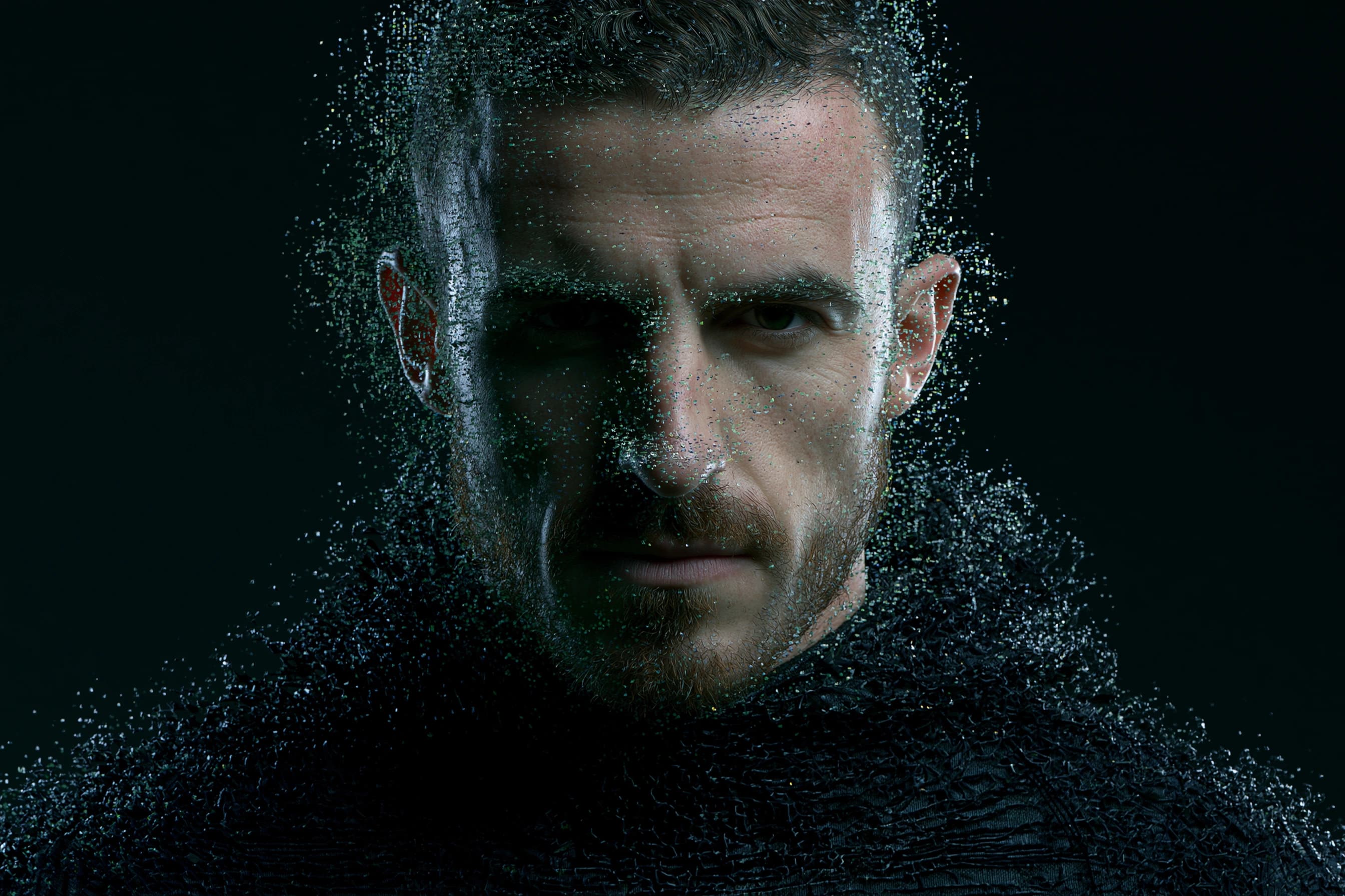 Close-up portrait of an athlete whose face dissolves into particles of light