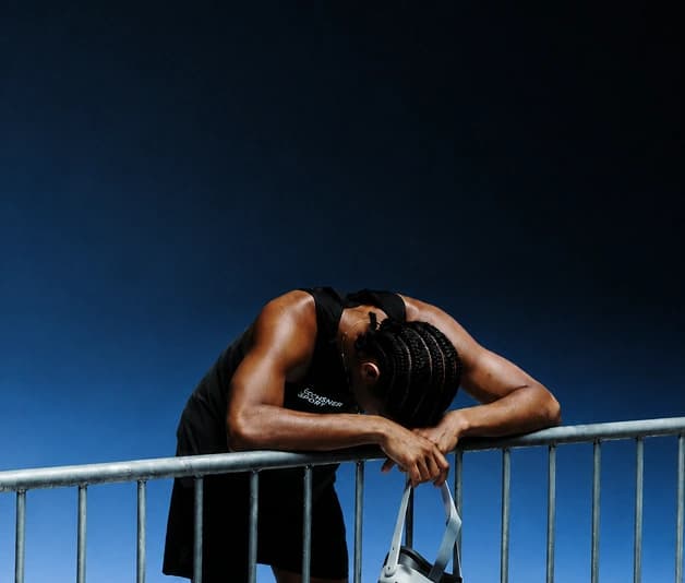 Man leaning on a railing outdoors