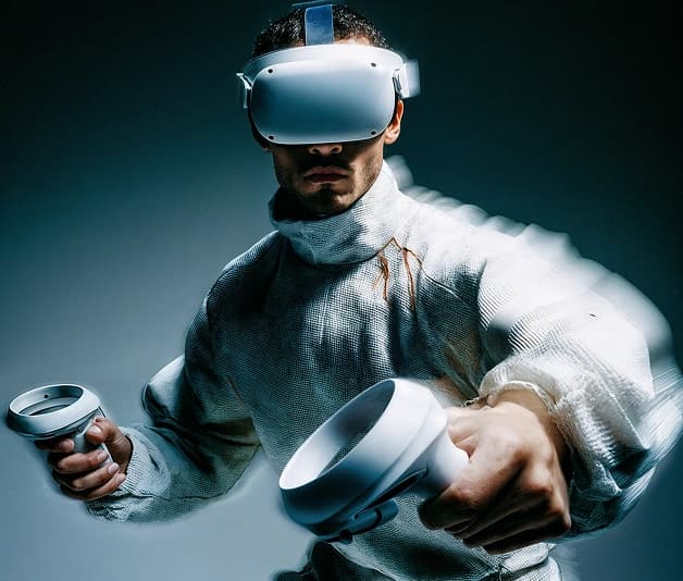 Man wearing a VR headset and holding motion controllers