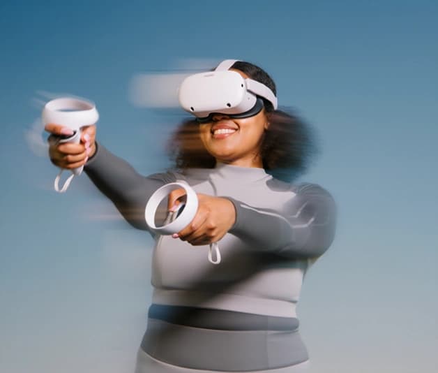 Person mid-motion wearing a VR headset and holding controllers
