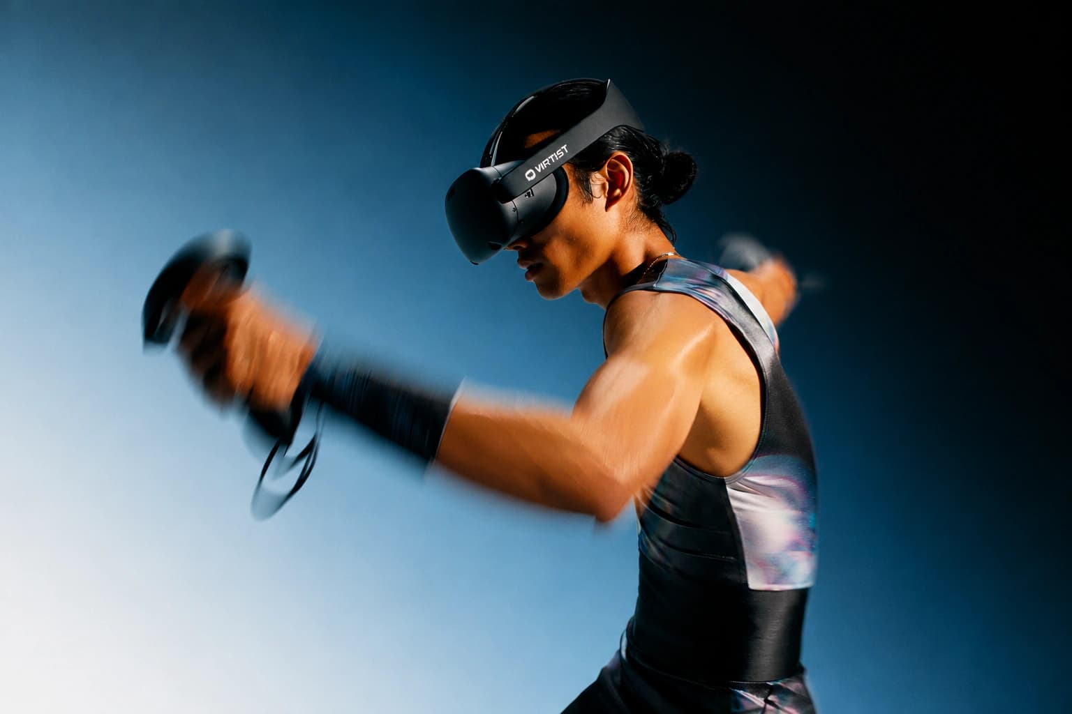 A VSHandball player in a VR headset swinging a motion controller against a blue backdrop
